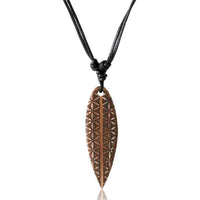 Load image into Gallery viewer, The Surferkette Holz Halskette Gravur Baumwolle verstellbar features a wooden surfboard-shaped pendant with geometric carvings, hanging from an adjustable black cotton cord—ideal as a unique surfer or friendship necklace.
