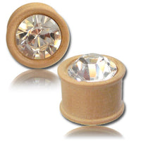 Load image into Gallery viewer, Two light Kristallinlay Holzplugs aus handgeschnitztem Teakholz mit rundem Kristall-Inlay glitzern im Licht. Die Tribal Plug Unisex Tunnel Expander Ohrringe werden aus verschiedenen Perspektiven auf weißem Hintergrund gezeigt.
