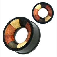 Load image into Gallery viewer, The "vierfarbig Holztunnel handgeschnitzt verschiedene Holzarten Tribal Tunnel Plug Expander" features a circular shape with a bold black rim and segments of brown, gold, and reddish-orange forming a striking geometric pattern.
