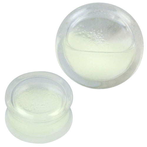 Two clear Plug Acryl samples for ear piercing, filled with white-yellow liquid, are displayed against a white background. Their rounded shapes and smooth surfaces are inspired by the Piercing Ohrschmuck design.
