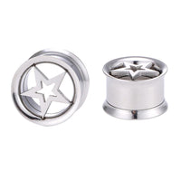 Load image into Gallery viewer, Two Schraubplug Tunnel Edelstahl Plug Stern im Stern silber ear gauges are shown—one stands upright displaying the star design, while the other is tilted to reveal its hollow, cylindrical side.
