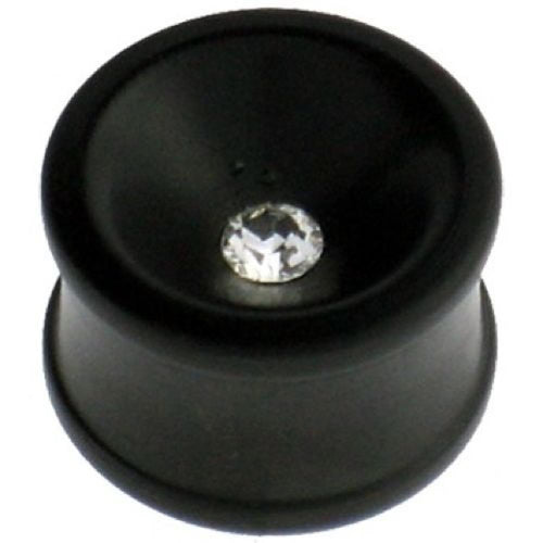 A hand-carved black Eisenholz plug with a concave shape and a clear Kristall at its center, inspired by Tribal Holzplug designs, is shown against a white background.