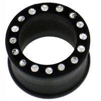 Load image into Gallery viewer, The schwarz Holztunnel Kristalle weiß is a hand-carved Ironwood ear tunnel plug, featuring a circular black design accented with a row of sparkling white crystals around the edge for an elegant tribal look.
