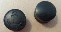 Load image into Gallery viewer, Two round black buttons on a tan surface: the left resembles a Flesh Plug Ebenholz Anker Seil Ring with anchor engraving, while the right is plain, similar to an Ebenholz plug.
