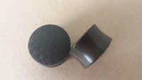 Load image into Gallery viewer, Two Flesh Plug Ebenholz Peace Knoten Muster double flared Lobe Dehner Ohrplugs in black rest on a tan surface—one reveals the engraved knot pattern, the other its smooth curve—an elegant pick for organic piercing fans.
