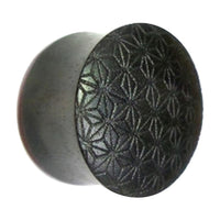 Load image into Gallery viewer, The Flesh Plug Ebenholz Stern Blume des Lebens is a double flared black lobe stretcher, engraved with the Blume des Lebens pattern and interlocking geometric shapes for a striking look.
