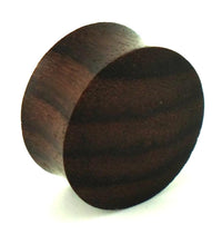 Load image into Gallery viewer, A circular, dark brown Teakholz Holz Plug Tunnel Expander Unisex Ohrschmuck with a smooth finish is shown angled, highlighting its cylindrical shape and flat surfaces against a white background.
