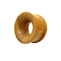 Load image into Gallery viewer, The Tunnel ocker Jackfrucht Holz handgeschnitzt ribbed is a single round ear gauge plug made from Jackfruit wood with ribbed detailing, a hollow center, and flared edges, shown against a white background.
