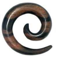 Load image into Gallery viewer, The Tribal Holz Piercing Expander Spirale in dark brown Sonoholz features smooth curves, a polished finish, and a stylish pattern—ideal as a plug, tunnel, or ear hanger.
