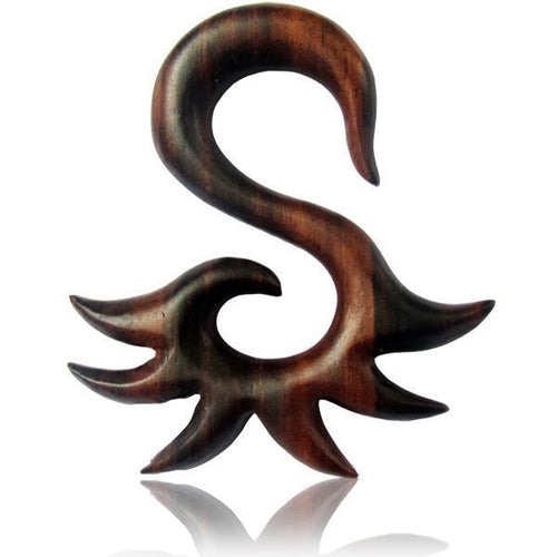 The Sonoholz Tribal Piercing Holz S-Form Spitzen Unisex Expander is a hand-carved, organic wooden decorative piece shaped like an abstract S with pointed, wave-like extensions, shown against a white background.