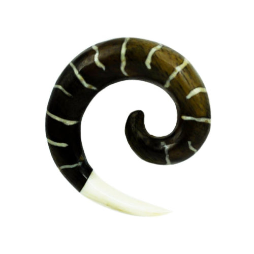 The Tribal Holz Piercing Expander features a dark brown spiral design with white bone inlay and a pointed bone tip, crafted from hand-carved Tamarindholz, making it a unique Plug Tunnel accessory.