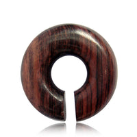 Load image into Gallery viewer, The Piercing Narraholz Holz Expander in dark brown is a large wooden ear expander with visible grain, featuring a central hole and narrow slit—ideal as an Ohrstecker, Ring, or Dehner for your lobe piercing.
