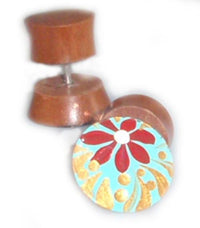 Load image into Gallery viewer, A pair of Tribal Fake Plug Holz Edelstahl Tunnel Sonoholz gauges: one hand-painted with a red flower, gold swirls, and blue background; the other shows its plain wooden side. Both are 1 mm and curved.
