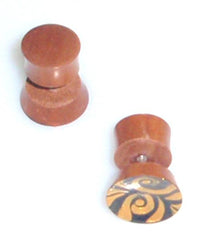 Load image into Gallery viewer, Two "Tribal Fake Plug Holz Edelstahl Tunnel Sonoholz" are shown, one upright and one on its side, displaying a hand-painted yellow and black swirl design reminiscent of a tribal plug or piercing expander.
