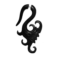 Load image into Gallery viewer, Hand-carved large fake piercing made from dark brown ebony wood and stainless steel, featuring intricate tribal patterns—Ebony "Ebenholz" Dehner, ideal as stylish Holz Ohrringe for a bold look.
