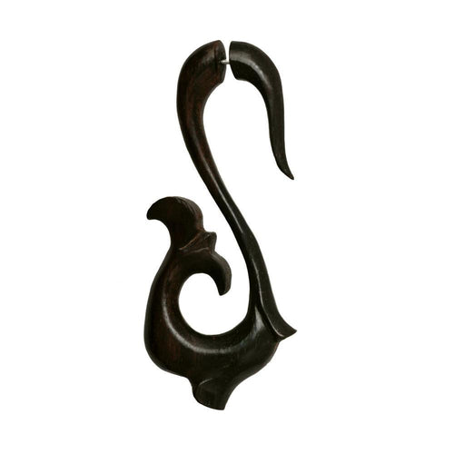 A large, hand-carved fake piercing Dehner made of dark brown ebony and stainless steel, featuring a flowing fish or dolphin design with a hook at the top—Product: Fake Piercing Ebenholz Edelstahl handgeschnitzt groß.