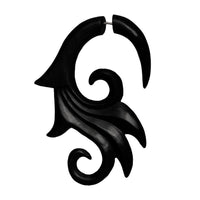 Load image into Gallery viewer, A single large fake piercing crafted from dark brown hand-carved ebony (Ebenholz) and stainless steel, featuring an abstract tribal swirl—ideal as a striking accessory.
