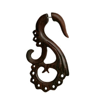 Load image into Gallery viewer, The Fake Piercing Sonoholz Edelstahl Dehner is a large, handgeschnitzte earring in light and dark brown wood, featuring intricate swirl designs and lace-like holes—an elegant organic accessory with a polished finish.
