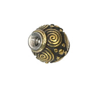 Load image into Gallery viewer, The "Kugel Bauchnabelpiercing Brass Edelstahl gold" features a round bead with gold spirals and dot designs on a dark base, plus a silver metal-lined center—perfect for those who love unique retro vintage styles.
