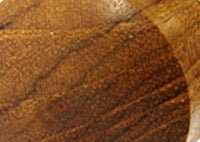 Load image into Gallery viewer, Close-up of a wooden surface with natural grain and brown shades, resembling the unique spiral twists of the Ohrring Holz Fake Piercing lange Spirale Edelstahl Dehnschnecke accessory.
