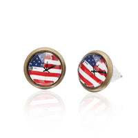 Load image into Gallery viewer, A pair of round, 12mm Brass Ohrstecker earrings, nickelfrei and unisex, with a colorful Sterne motif under a clear dome and bronze-colored edges.
